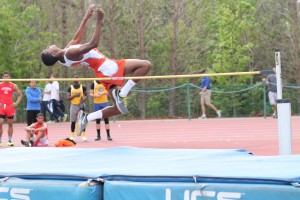 HIGH JUMP. Clearing the pole, junior Jamal Clark jumps a personal record of 5 feet 4 inches. photo/LIZZY GORDON