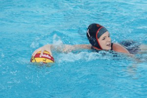 UP FEILD. Captain Nicole Clayton dribbling up the pool latter assisting a goal to Julia Hester.