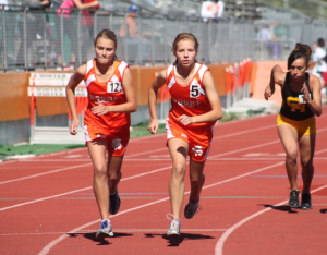 DETERMINATION. During the 1600-meter run Alexandra Sublette and Claire Collins pump their arms. photo/LIZZY GORDON