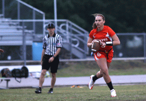 SWITCHING IT UP. Senior quarterback Bailey Florin runs the ball until she finds an open player in the game on April 5 against Cypress Creek. photo/BRIDGETTE NORRIS