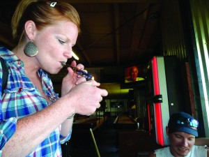 BLAZE IT. A woman smokes marijuana in a bar in Washington. photo/ MCTcampus