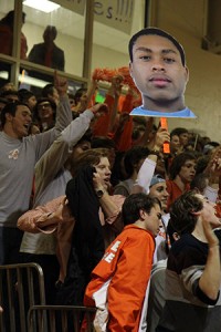 BIG HEAD. Student crowd celebrates the team victory by waving a Barry "BJ" Taylor Big Head.