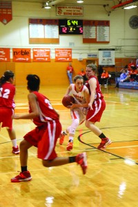 JUST PASSING BY. On her way to the basket, junior Cassandra Ketchum runs past a Lake Mary defender. photo/AMELIA CHEATHAM