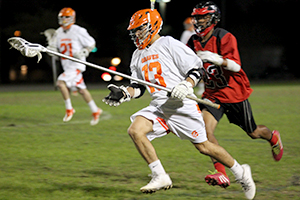 SPEED. On March 5, long stick middie sophomore Mitchell Capps runs the ball towards the goal. photo/ KRISTEN DUGAN