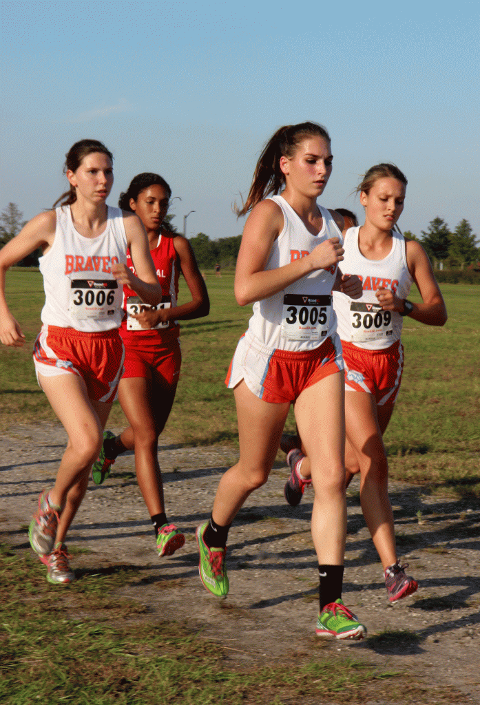 TAKE OFF. Running as a pack, sophomore Jessica Dolan, senior Cassidy Malott, and junior Alexandra Sublette approach their first mile marker. photo/Elizabeth Porterfield