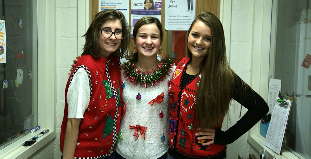 HOLIDAY CHEER.  In the festive mood, freshmen Carly Meyer, Alexa Withey and Charly Reynolds wear their ugly sweaters.
