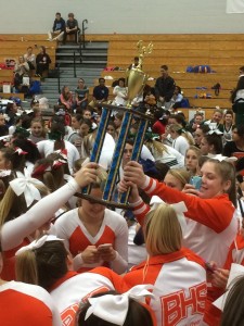 CELEBRATE. Posing for the picture,  junior Kaitlin Garrett smiles  while holding the trophy. 