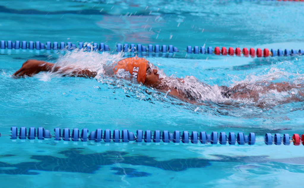 TO THE FINISH LINE. Junior Victoria Pratt works to complete the 100 Backstroke. photo/Avery Tyndall