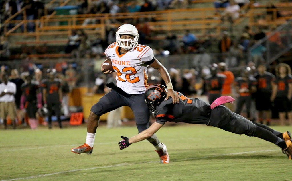 BREAKING TACKLES. Brandon Bush stiff arms Winter Park player and is on his way for a long first down.