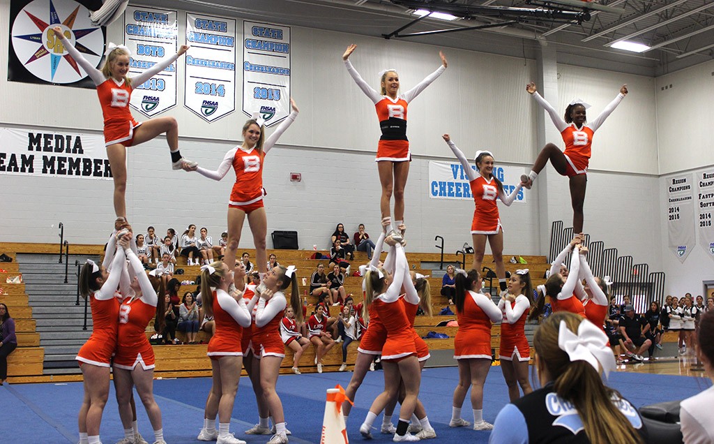 HIT IT. The cheer team sticks the pyramid. photo/Abby Hutsell