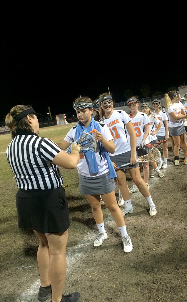 Lady Braves lacrosse has there sticks checked before the start of their game against Wekiva High School.