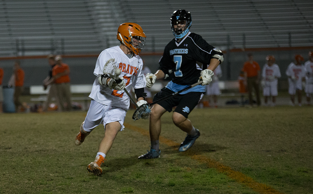 MOVE IT. With a Panther defender on him, senior Luke Magley works to head downfield. photo/Payton Hoevenaar