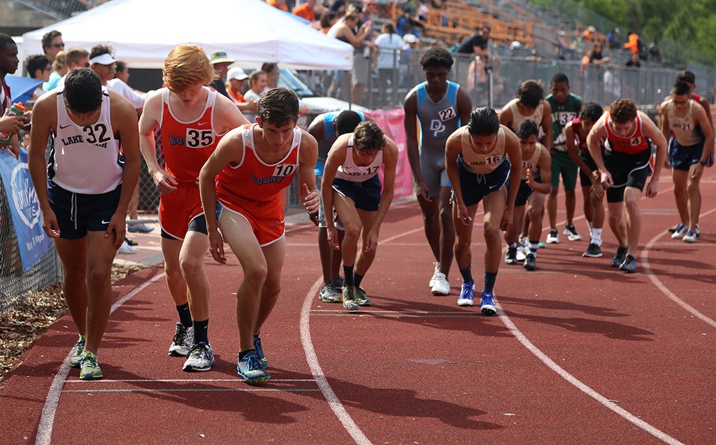 ON YOUR MARK. Sophomore Eric Tormanen and Senior Clayton Partlow prepare to run the 1600-meter race. photo/Jae Crawford