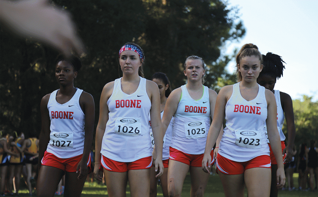 GAME FACE. The Junior Varsity team head to the starting line focused and warmed up. photo/Madison McCoy