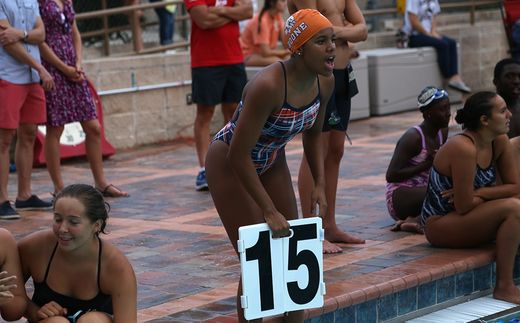 SUPPORT. At the end of the pool, senior Victoria Pratt cheers on her teammates. photo/Jack Rummler