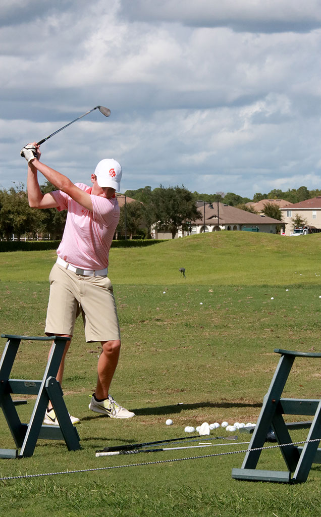WARM UP. Before the match sophomore Colin Smith works on his swing. photo/Grace Asbury