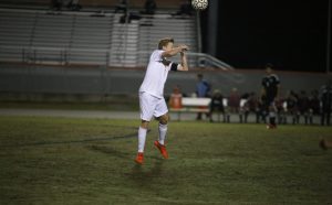 GET YOUR HEAD IN THE GAME. Senior Hunter Reddick heads the ball. photo/Douglas Page