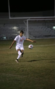 IT'S FREE. After receiving a free kick, junior Jonathan De Lucca kicks the ball down the field. photo/Douglas Page 