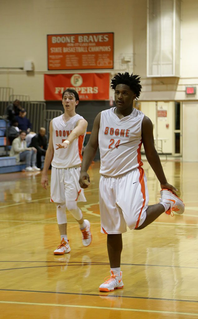 DEFENSE. Senior Justin Butler gets ready for Colonial to come down the court. photo/Molly Cooper