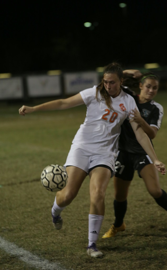 LET'S GET IT. Senior Jacey protects the ball from incoming Titian player. photo/Charly Reynolds
