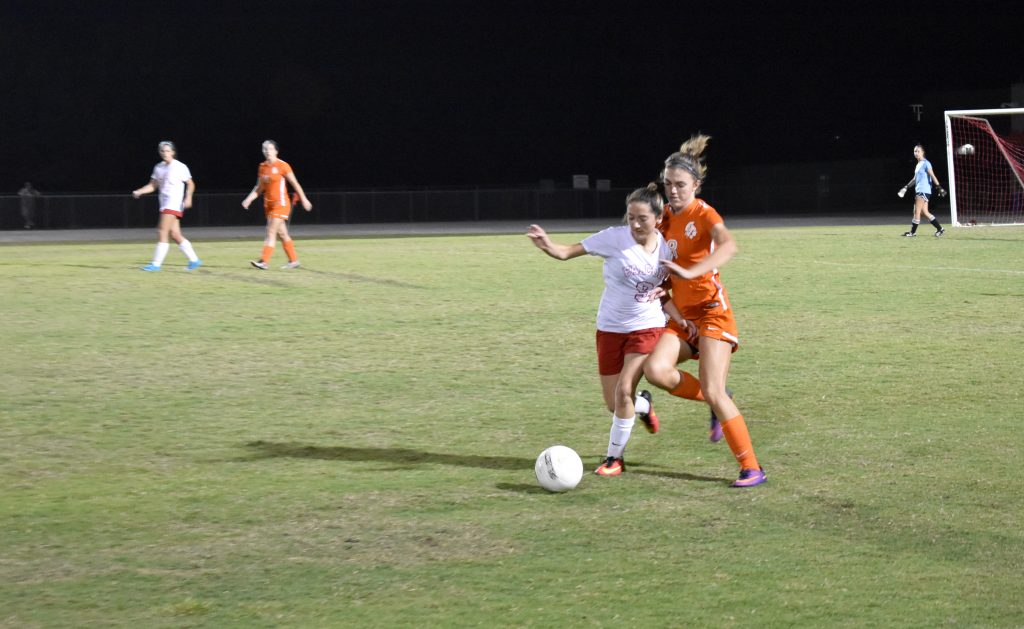 WATCH OUT. Senior Olivia Page steals the ball from East River. 