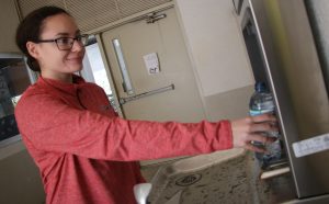 QUICK AND CLEAN. After drinking a bottle of water, senior Raeanna Pabon refills the water bottle at a new station. photo/Jessie Jalca