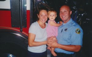 With her parents at the fire station