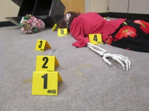 Biomedical students use crime scene simulations to understand the medical and legal processes of autopsy reporting. Photo by Annie Magee.