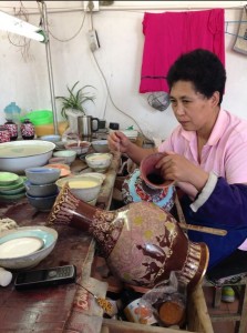A woman painting handmade Chinease vaces that are later exported to other countries. PHOTO/Rabeea Summer Rehman