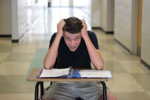 PHOTO/ Andrea Rivera: Freshman Lucas Bryson is overwhelmed by the load of work he needs to complete. 