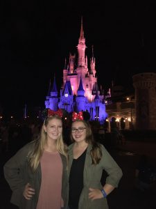Senior, Katie Dumond and Junior, Sydney Macdonald pose in front the Disney/Cinderella Castle at night. Photo Donated by Katie Dumond.