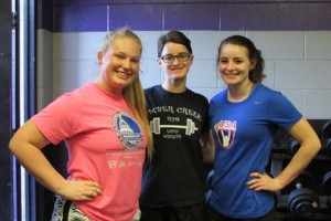 Lauren Snyder, Emily Brunell, Micala Brunell smiling at Monday’s practice."Yeah, you could say it's a family thing. We've been lifting together for six years." -Emily Brunell