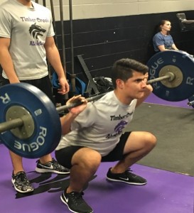 Fabio Marcia is seen here lifting 110lb. He uses all his energy to lift the weight. He has support from another athlete on the team (behind Fabio). This was taken at one of their practices on February 25. 